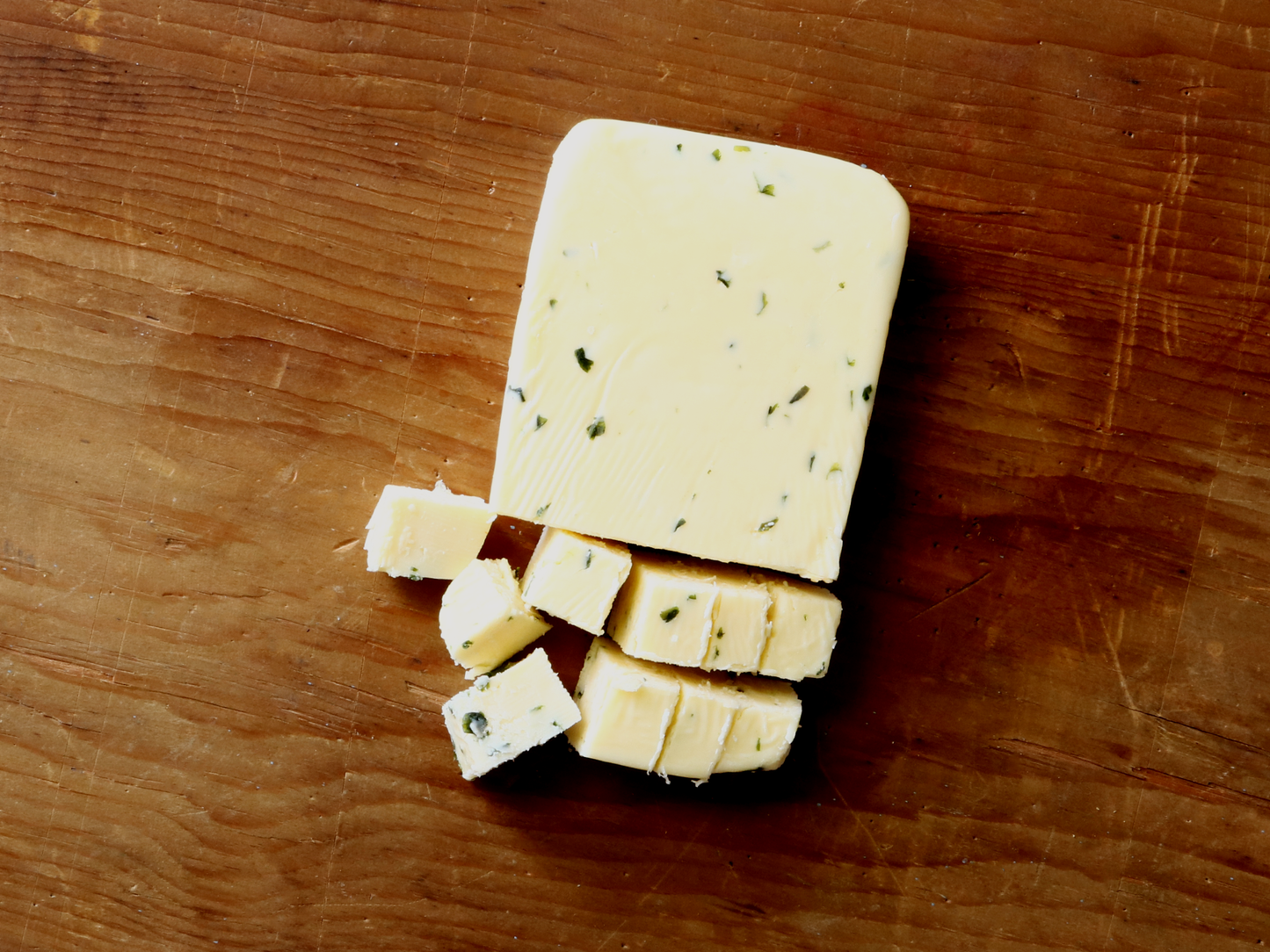 Widmer's Butterkase with Chives on Wood Background