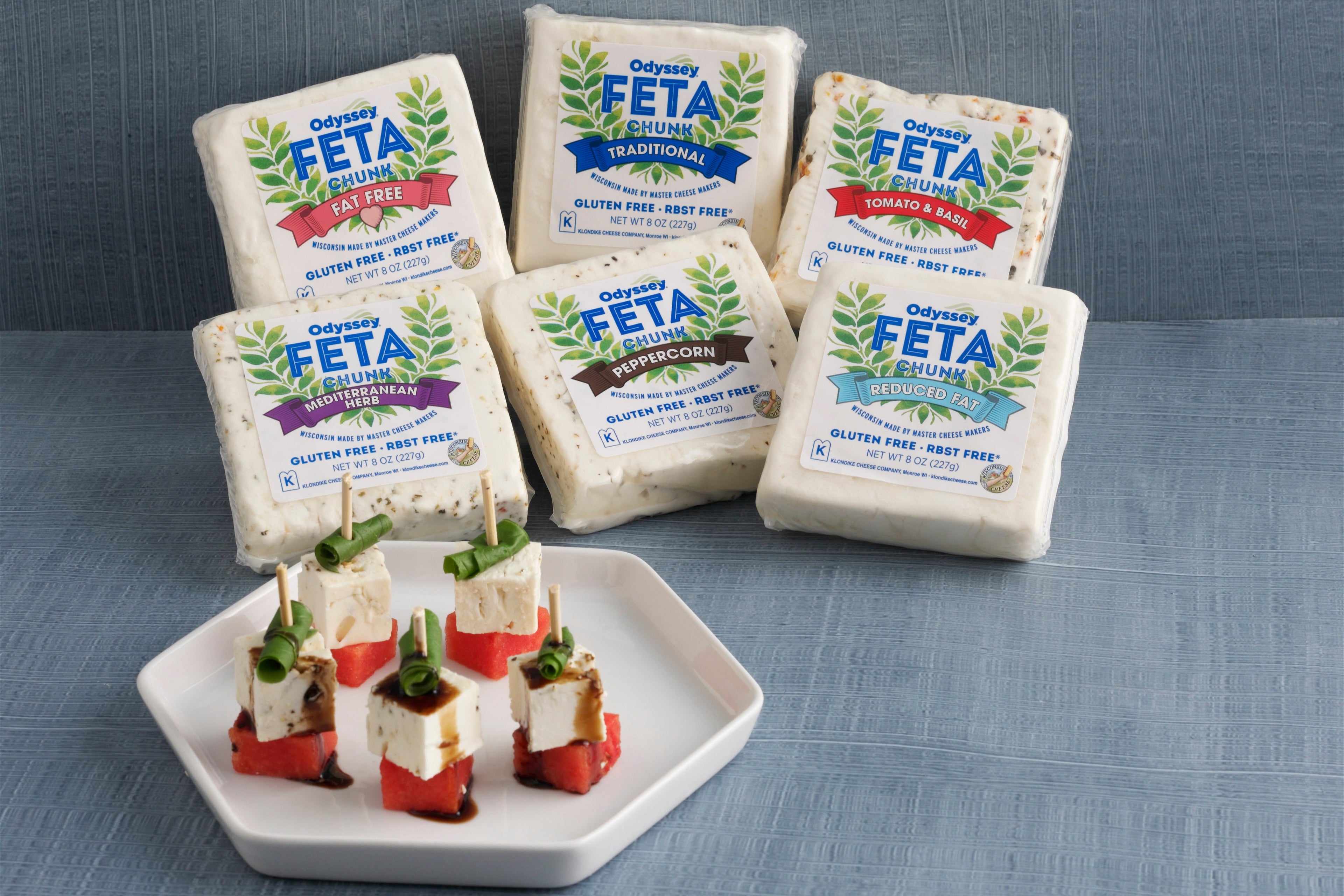Feta cheese blocks with packaging on a gray surface