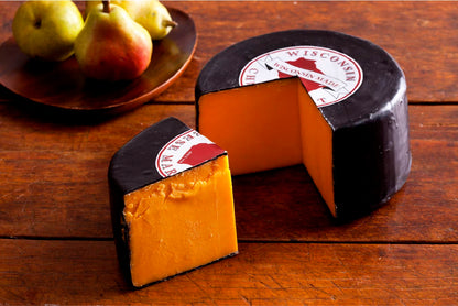 5 pound wheel of sharp cheddar cheese in black wax