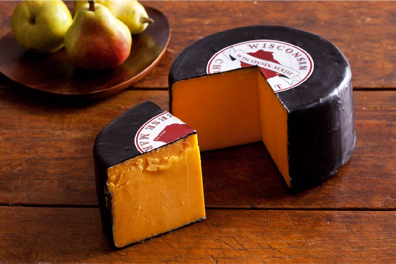 5 pound wheel of sharp cheddar cheese in black wax